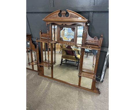 Late Victorian American walnut over mantel mirror with eight panels of bevelled glass surrounded carved decoration and turned