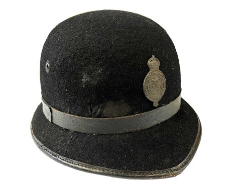 Royal Ulster Constabulary one piece bowler-shaped policeman's helmet with black leather band and black Queen's crown helmet b