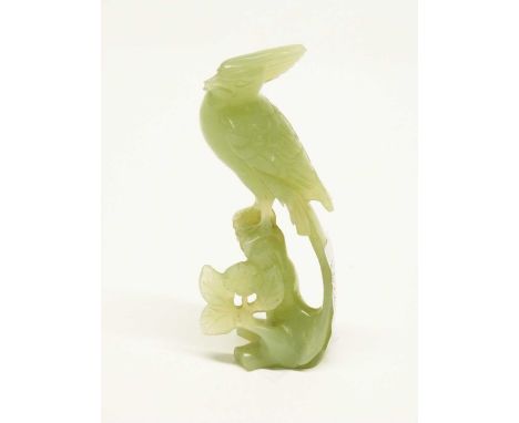 Jade model of a bird on a rock with carved flowers beneath, 12cm high