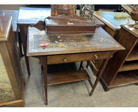 A small Edwardian writing table with a hinged storage compartment, worn leather writing surface and a single freize drawer ov