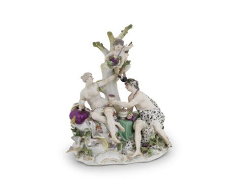 A Meissen Bacchanalian group, circa 1750-60Modelled with Bacchus and a nymph seated on rockwork in front of a tree with two c