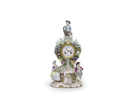 A Meissen mantle clock, circa 1900On a rockwork base with three pastoral figures, edged with scrollwork heightened in gilding