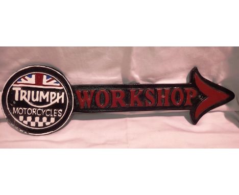 Cast iron Triumph workshop arrow, L: 40 cm. P&amp;P Group 2 (£18+VAT for the first lot and £3+VAT for subsequent lots) 