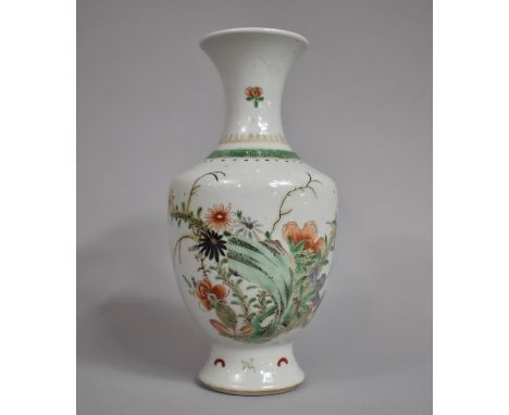 A Chinese Famille Verte Vase, Kangxi Period, decorated with Blossoming Branches and Butterflies. 24.5cms High 