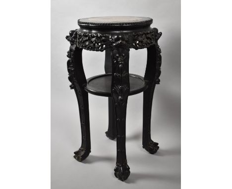 A Carved Chinese Circular Hardwood Vase Stand with Marble Top, Stretcher Shelf and Claw and Ball Feet. 82cms High, 40cms Diam