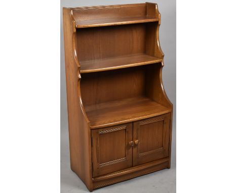 An Ercol Standing Open 'Golden Dawn' Waterfall Bookcase with Base Cupboard, 60.5cms Wide and 110.5cms High 