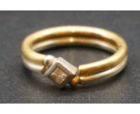 A white and yellow gold ring set square diamond, stamped 750, size T, gross weight 8.2g. 