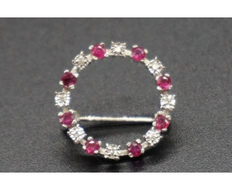 A 9ct white gold ruby and diamond brooch, 2cm diameter, gross weight 2.6g. 