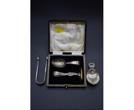 A pair of Victorian silver sugar tongs, London 1888, together with a silver shell caddy spoon, Sheffield 1982; and a cased si