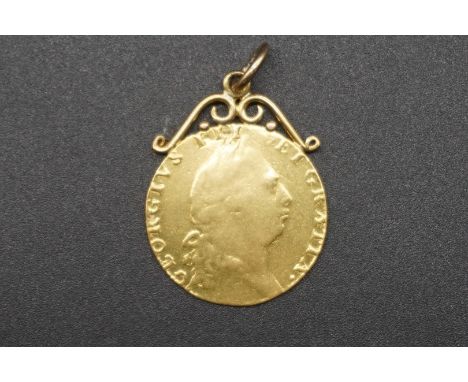 Coins: a George III 1793 gold guinea, with attached pendant suspension ring, 9.2g gross. 