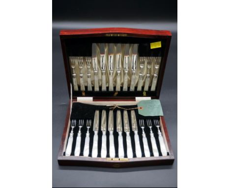 A mahogany cased set of twelve pairs of silver and mother-of-pearl dessert knives and forks, by Harrison Brothers &amp; Howso