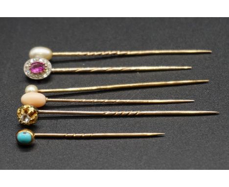 A yellow metal amethyst and diamond cluster stick pin, 5.6cm; together with a diamond set stick pin and four others. (6) 