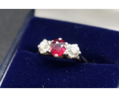 A ruby and diamond three stone ring, size N. 