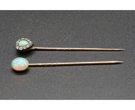 A yellow metal stick pin set oval cabochon opal, 6cm; together with a turquoise and diamond stick pin. (2) 