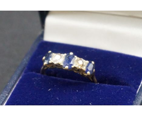 A yellow metal ring set two diamonds and three sapphires, stamped 18c, size L. 