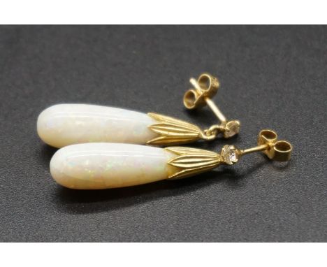 A pair of opal and diamond drop earrings, in a yellow metal setting, 33m long, both butterflies stamped '750'. 
