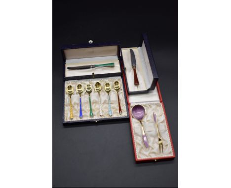 A small collection of Danish silver and enamel items, comprising: a set of six gilt coffee spoons; a small gilt fork and spoo