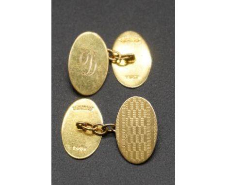 A pair of 9ct gold oval engine turned cufflinks, 6.1g. 