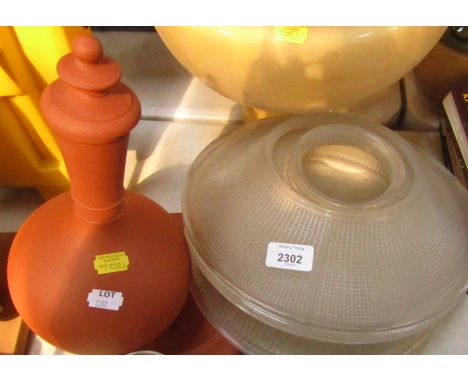 Three oil lamp shades, terracotta bottle, stopper and stand.