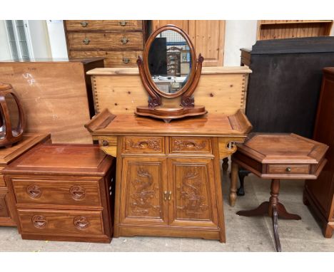 A Chinese hardwood Altar table with a shaped top, with two drawers and two cupboards carved with dragons together with a Chin