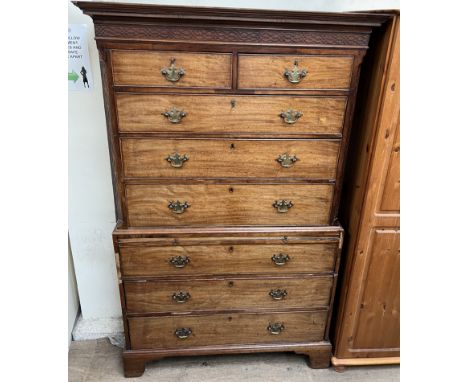 A 19th century mahogany chest on chest, with a moulded cornice above a blind fretwork frieze and canted corners, the top sect