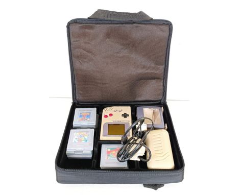 A white Nintendo Game Boy, with various games including Tetris and Super Mario Land, cased, with Light Magic screen and recha