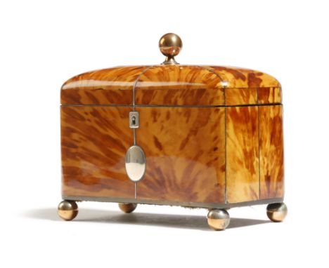 λ A Regency tortoiseshell tea caddy, with white metal stringing, escutcheon and a vacant plaque, the dome hinged lid with a c