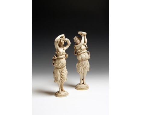 λ A pair of 19th century French Dieppe carved ivory dancing girls, one playing the tambourine with articulated zils, the othe