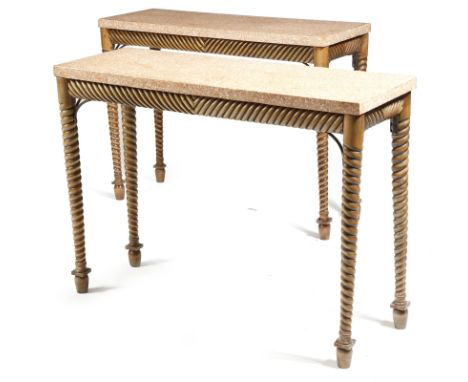 A pair of 19th century continental fruitwood console tables, each with a composite marble top, above a ribbed frieze and on s