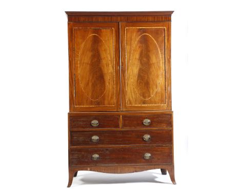 A Regency mahogany linen press, with a pair of kingwood banded oval panelled doors, enclosing three slides and a shelf, 198.6