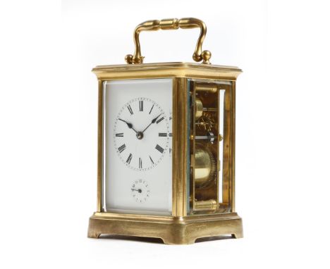 A late 19th century French gilt brass repeating carriage clock with alarm, with a platform lever escapement, the repeating mo