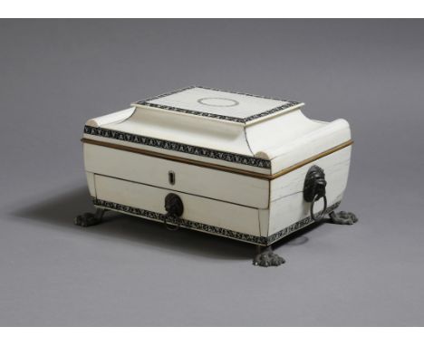 λ An early 19th century Anglo-Indian ivory workbox, of sarcophagus shape, with bands of lac decoration, the hinged lid decora