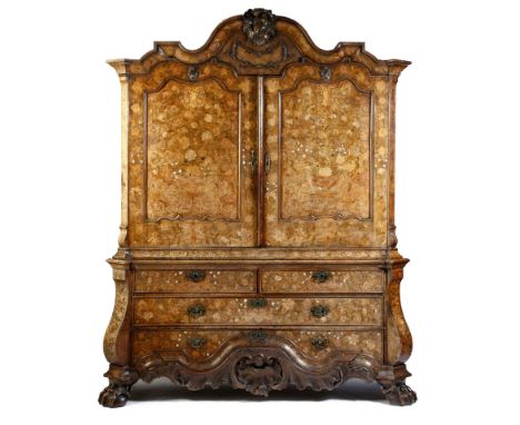 λ An 18th century Dutch walnut and marquetry kas or armoire, inlaid with fruitwoods, mother of pearl and ivory, with urns of 