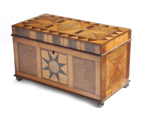 λ An early 19th century parquetry tea caddy, inlaid with burr, oak, rosewood and satinwood, with geometric designs, the inter