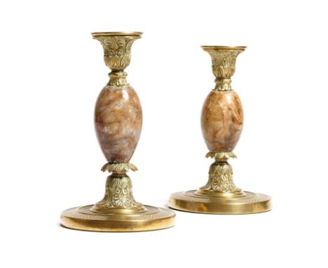 A pair of Regency blue john and brass candlesticks, each decorated with palmettes and with a baluster stem on a circular base