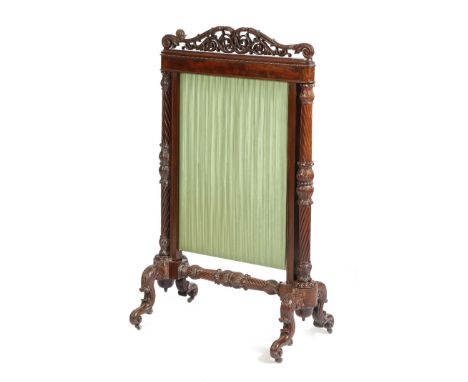 A William IV mahogany firescreen in the manner of Gillows, profusely carved with scrolling leaves and lappets, with a pleated