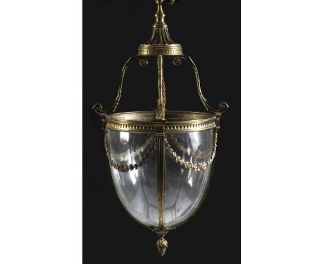 An Adam style brass hall lantern, with leaf capped scroll supports above an ovoid body decorated with floral swags, 67.4cm hi