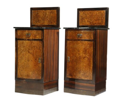 A pair of Art Deco calamander and burr wood bedside cupboards, each with a raised back above a black marble top, a drawer and