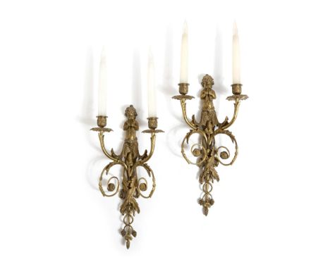 A pair of French ormolu twin-light wall appliques in Louis XVI style, each with a backplate modelled with Pan playing pipes, 