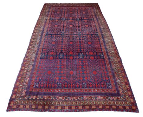 A Khotan carpet, with an all over pomegranate design, Xinjiang, east Turkestan, first half 20th century, 620 x 316cm.Click he