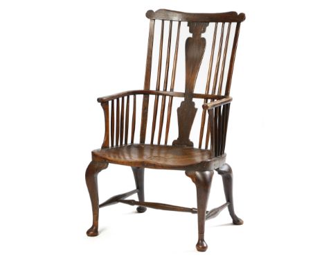 A mid-18th century fruitwood and ash Windsor armchair attributed to John Pitt, the comb back above a solid vase shape splat, 