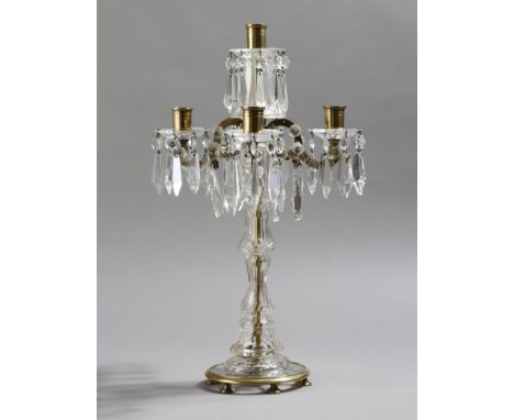 A cut glass and brass five light candelabra by Lobmeyr, with scroll arms with applied discs, the drip-pans hung with cut glas