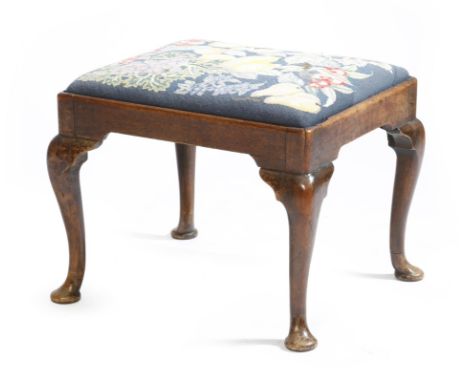 A George II mahogany stool, with a later needlework drop-in seat decorated with fruit, on cabriole legs and cut pad feet, 46.