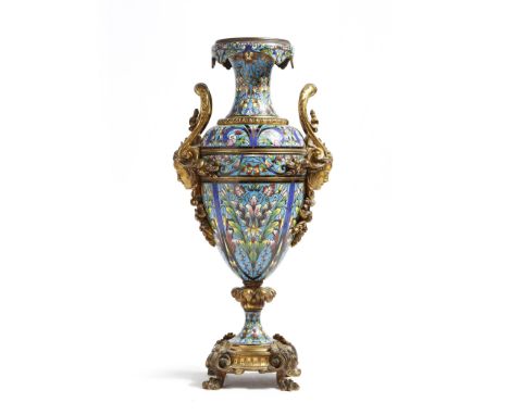 A late 19th century French ormolu and champlevé enamel urn, decorated overall with scrolling leaves and flowers, with female 