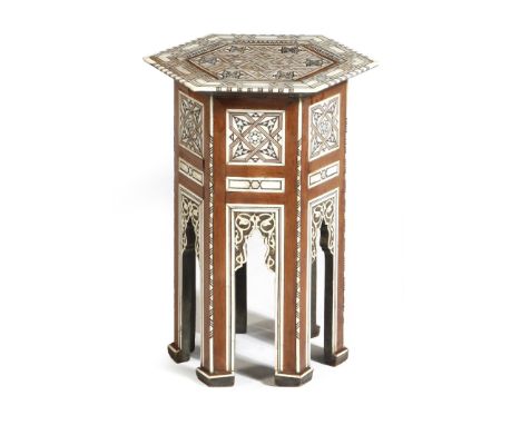 A late 19th century Moorish walnut and bone hexagonal occasional table, inlaid with mother of pearl, with geometric and star 