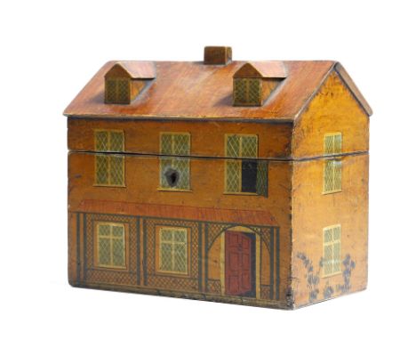 λ A 19th century painted tea caddy in the form of a house, with dormer windows to the hinged top, enclosing twin lidded compa