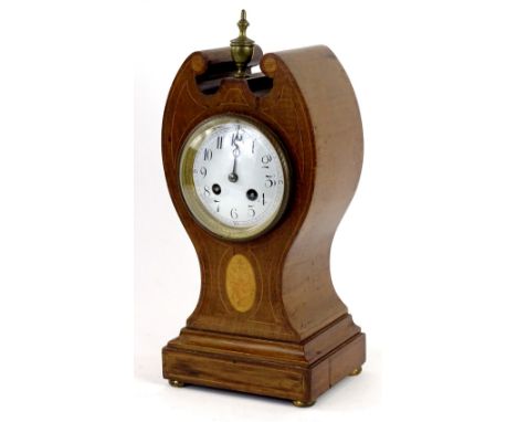 An Edwardian mahogany and marquetry tulip shaped mantel clock, with a turned brass finial, the enamel dial with Arabic numera