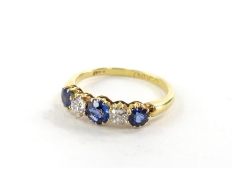 An 18ct gold sapphire and diamond five stone ring, the ring head set with three round brilliant cut sapphires, the central st