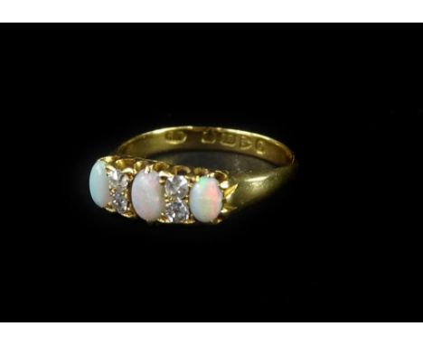 An 18ct gold opal and diamond gypsy ring, set with three oval opals, and four tiny diamonds, in claw setting, ring size O, 4.