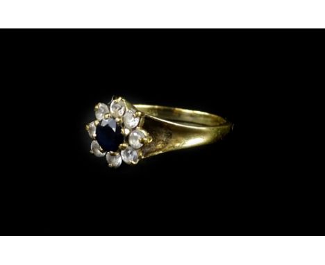 A 9ct gold cluster dress ring, with central dark blue stone, surrounded by imitation diamonds, ring size L, 2.6g all in. 